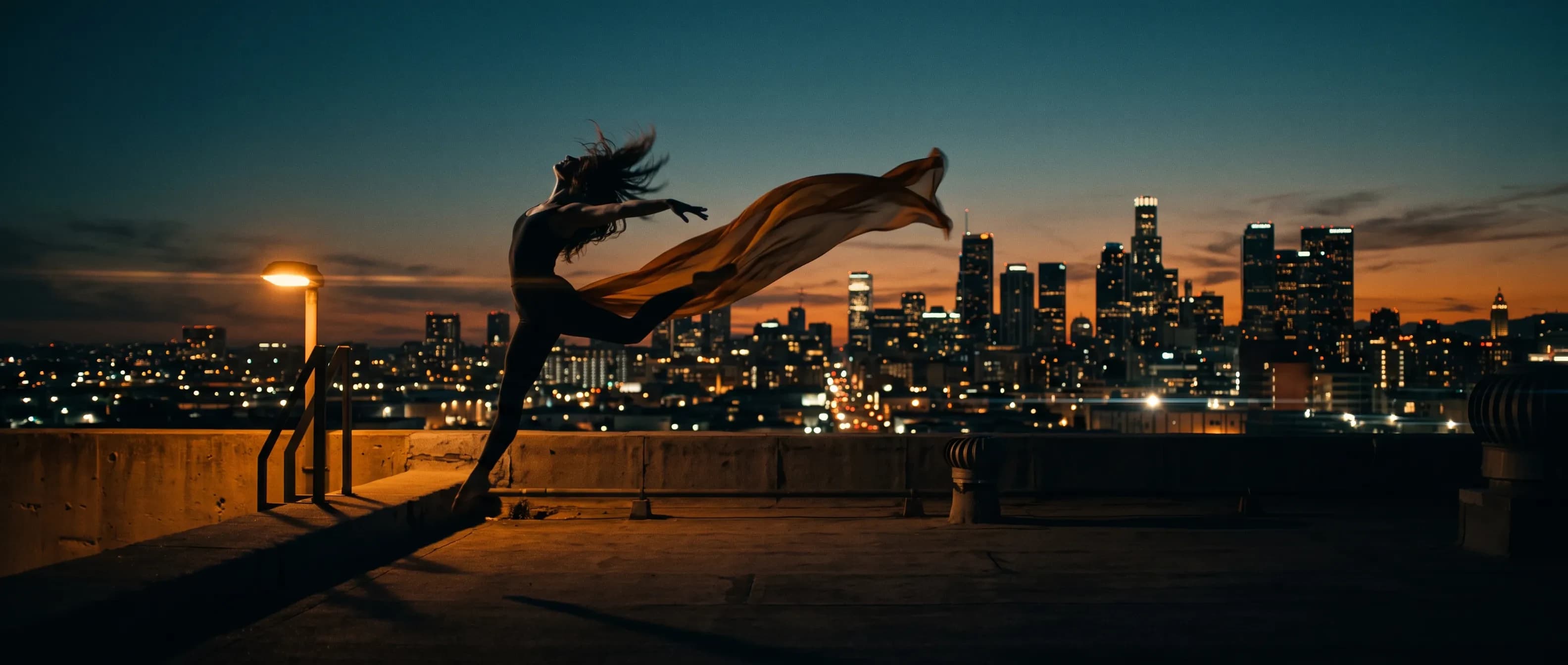 A dancer mid-leap on a rooftop at dusk, made in this studio